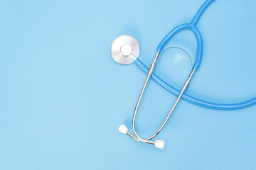 stethoscope for a doctors examination on the background of a medical laboratory health table with space for text. blue background