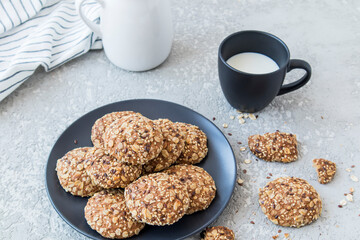 delicious healthy breakfast. oatmeal homemade cookies on a plate with a cup of fresh milk.