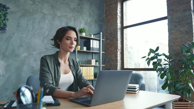 Professional lady sit table use netbook prepare report in workstation