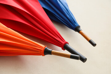 Colorful umbrellas on light background, closeup