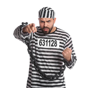 Angry prisoner in special uniform with chained hands on white background
