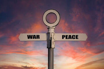 Old road sign with war and peace pointing in opposite directions.  Pro anti war concept
