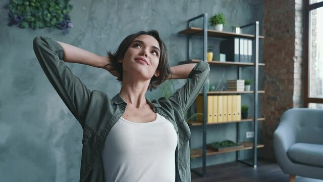 Expert lady sit table break hands head use netbook in modern workspace