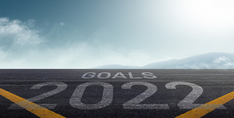 happy new year 2022. road to 2022 goals concept. text 2022 and goals written on the road background.