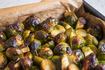 oven baked sliced brussels sprouts on baking tray closeup