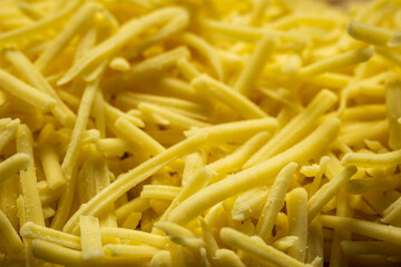 grated cheddar cheese background closeup