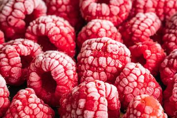 frozen red raspberries background closeup