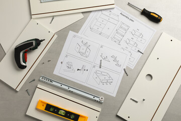 Flat lay composition with furniture parts and tools for self-assembly on grey background