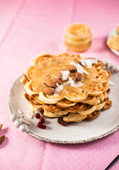 Freshly baked homemade heart shaped Belgium waffles on pink background. European baked pastry sweets. St. Valentine's Day breakfast concept.