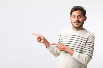 Young indian man giving expression on white background.