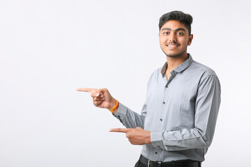Successful Young indian business man posing over white background.