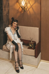 Beautiful woman close up on the decorated fir-tree background. Gatsby style
