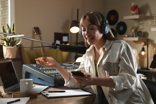 Woman working as radio host in modern studio