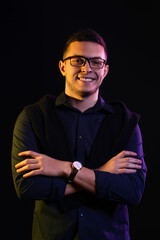 Obraz premium Toned portrait of handsome young man on black background
