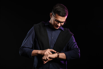 Portrait of handsome young man on black background