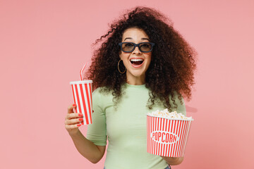 Fun excited cheerful young curly latin woman 20s wear mint t-shirt in 3d glasses watch movie film...