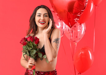 Sexy young woman with balloons and flowers on color background. Valentine's Day celebration