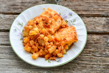  Potato and minced meat  Casserole  with   parmesan cheese and garlic on wooden rustic bakcground.  Bulgarian moussaka