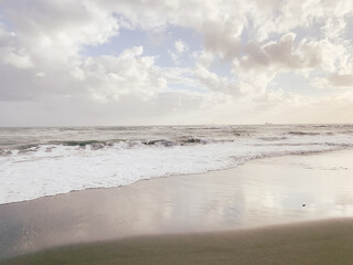 Amazing sky reflection at the sea coast, sand beach, evening time, natural background