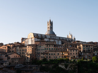 Fototapeta na wymiar Siena Cathedral Belfry Cityscape in Tuscany or Townscape with Duomo di Siena Bell Tower