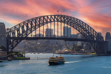 View of Sydney Harbour NSW Australia. Ferry boats partly cloudy colourful skies blue waters