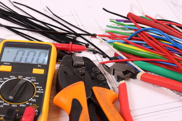 Colored electrical wiring wires, mounting tools, multimeter, are arranged in a schematic diagram.