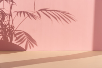 Premium podium with a shadow of tropical palm leaves on a pink and beige background. Minimal...
