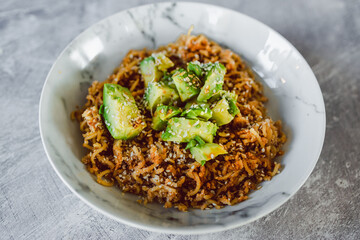 vegan ginger noodles with avocado sesame and fried onion topping, healthy plant-based food