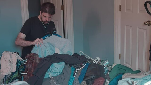 hoarder sorting through clothes