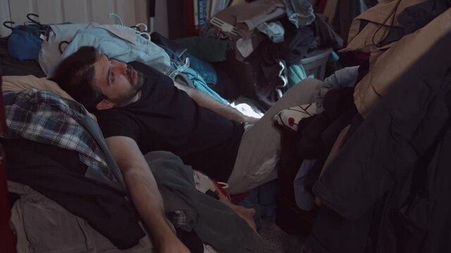 sitting in clothing horde