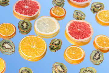 Citrus fruits collection food background oranges lemons kiwi grapefruit fresh fruit backgrounds . Slices of grapefruit lemon orange and kiwi on a sky background. Citrus food