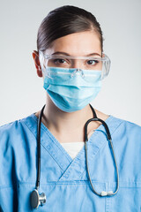 Portrait of serious woman doctor isolated on white background