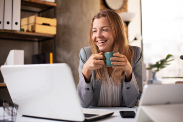 Happy businesswoman working on laptop. Portrait of beautiful businesswoman having video call.