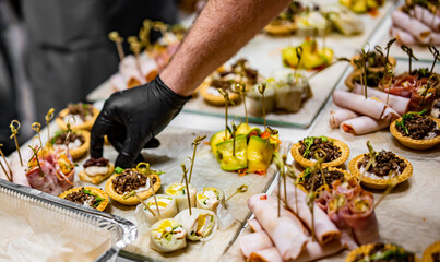 Chef hand is in process of Preparing catering food