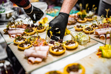 Chef hand is in process of Preparing catering food