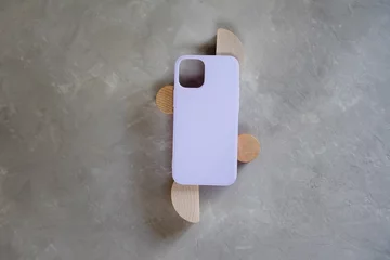 Afwasbaar Fotobehang Pantone 2022 very peri Lilac silicone case for smartphone on a gray textured background. Color concept - very peri color of the year 2022.