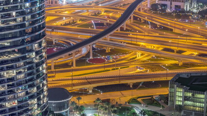 Highway intersection and overpass of Dubai downtown aerial night timelapse.