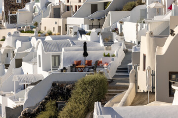 Whitewashed houses with terraces and pools and a beautiful view in Imerovigli on Santorini island, Greece