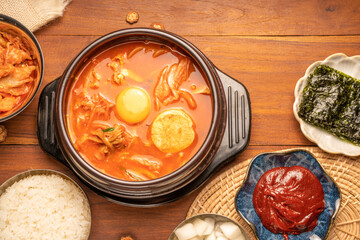 Kimchi stew or Kimchi soup, Korea’s national dish spicy soup with vegetable, meat, eggs, tofu served in a hot pot. Kimchi Jjigae korean trditional food.