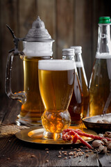 Light beer in a glass on an old background.