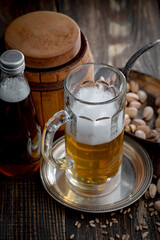 Light beer in a glass, on an old background.