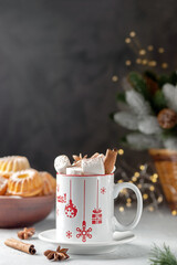 Marshmallows and a cup of latte on the background of Christmas tree