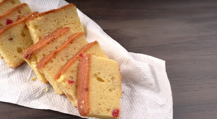 Slices of home made wholemeal bread on a white background with wheat and flour.