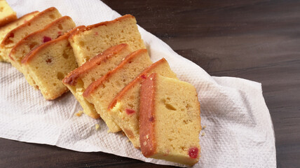 Slices of home made wholemeal bread on a white background with wheat and flour.