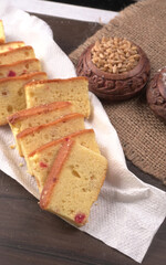 Slices of home made wholemeal bread on a white background with wheat and flour.