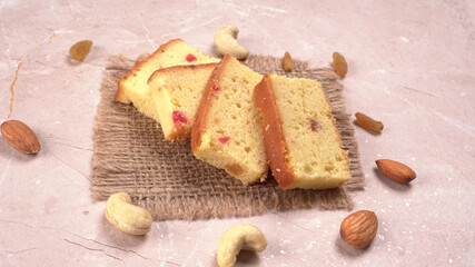 Slices of home made wholemeal bread on a white background with wheat and flour.