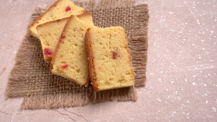 Slices of home made wholemeal bread on a white background with wheat and flour.
