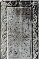 Ancient stone with medieval latin writing. Ancient church