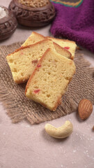 Slices of home made wholemeal bread on a white background with wheat and flour.