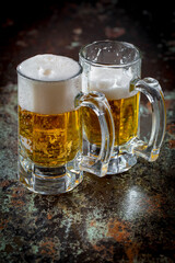 Light beer in a glass on an old background.